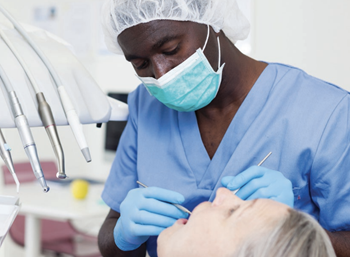 dental hygienist performing exam